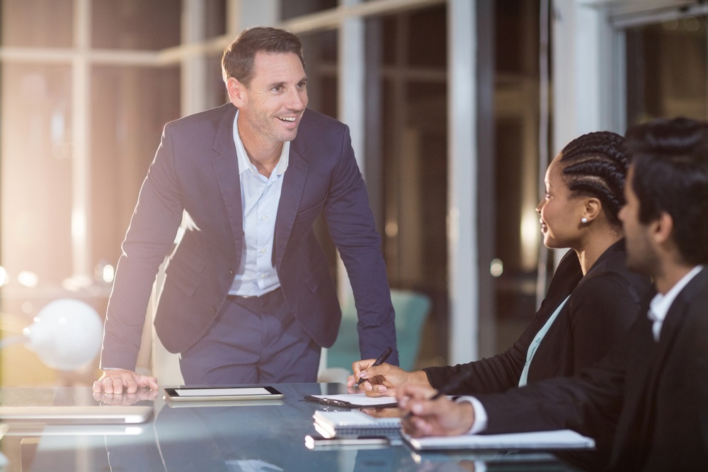 Businessman interacting with coworkers in a meeting in the conference room